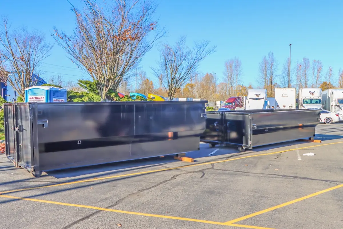 Professional dumpster rental service with roll-off container on residential driveway in St. Paul Park